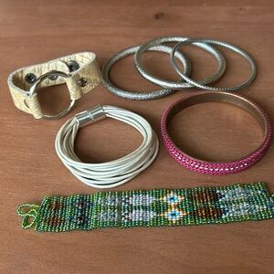 Collection of bracelets 2 leather bracelets 4 metal and a woven beaded bracelets